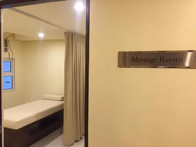 a bedroom with a massage room sign on the wall at 101 Newport City near NAIA 3, Pasay City in Manila