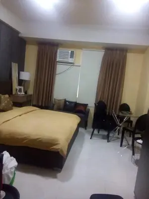 a hotel room with a bed and a living room at 101 Newport City near NAIA 3, Pasay City in Manila