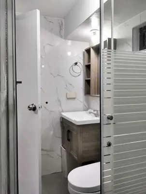 a bathroom with a toilet and a sink at Affordable 2 BR 2 BA w/ Skycable, Netflix, & Amazon Prime in Manila