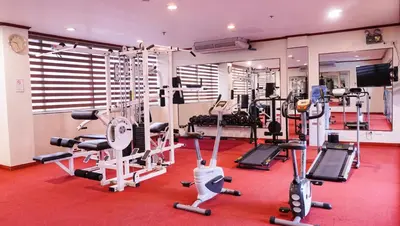 a gym with several tread machines in a room at Bayview Park Hotel Manila in Manila