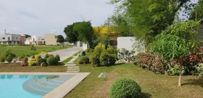 a swimming pool in a yard next to a house at Julzhome PH Properties by Juliet AfricaPervaze in Santa Rosa