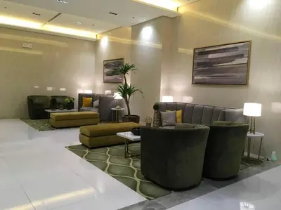 a lobby with couches and chairs in a building at 101 Newport Blvd Condotel in Manila