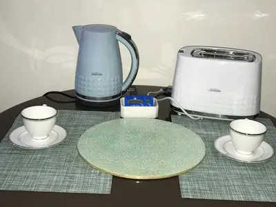 a table with a blender and cups on a table at Chillax Studio 101 Newport Boulevard in Manila