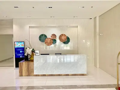 a lobby with a reception desk in a building at Chillax Studio 101 Newport Boulevard in Manila
