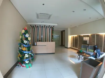 a christmas tree in the middle of a living room at Palm Tree 2 Villas-Cluster 2 Unit 3N in Manila