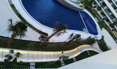 a view of a slide at a resort with palm trees at Azure C6 Balcony Wifi near Mall Airport MULTIPL UNITS in Manila