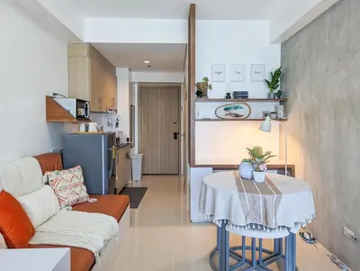 a living room with a couch and a table at Studio Condo Manila by the Bay Roxas Blvd near US Embassy in Manila