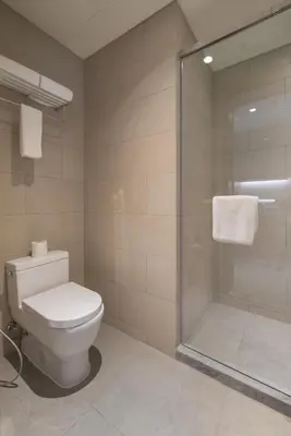 a bathroom with a toilet and a shower at Citadines Bay City Manila in Manila
