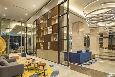 a living room with a large glass wall at Citadines Bay City Manila in Manila