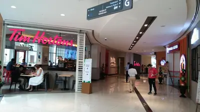 a shopping mall with people walking around a store at Makati Condo Edsa MRT Magallanes Station Chino Roces Ave cor EDSA IT Hub ONE Ayala Alphaland WiFi by 24K Residences in Manila