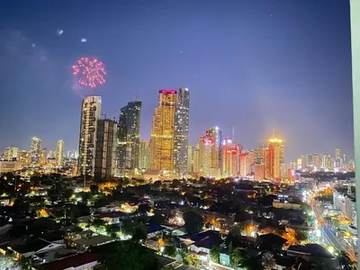 a city at night with fireworks in the sky at Will’s Place at Jazz Makati in Manila