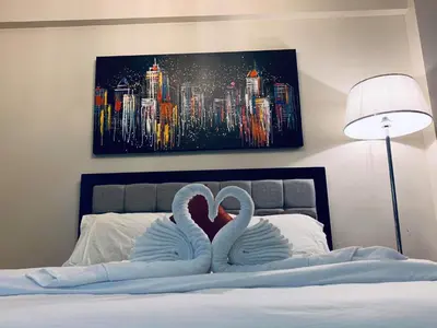 two swans arerendered to be kissing on a bed at H&M One Palmtree Villas in Manila