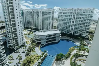 an aerial view of a building with a swimming pool at Azure Urban Resort Residences - The Paris Hilton Beach Club in Manila