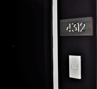 a clock on a wall with a lightswitch at ACQUA Private Residences 1BR Condo in the heart of downtown Makati & Mandaluyong in Manila