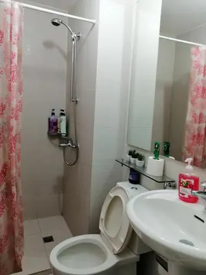 a bathroom with a toilet and a sink and a shower at ACQUA Private Residences 1BR Condo in the heart of downtown Makati & Mandaluyong in Manila