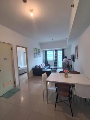a living room with a table and a couch at Spacious 2BR in Jazz Residences Makati in Manila
