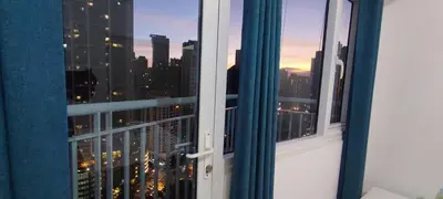 a view of a city skyline from a window at Spacious 2BR in Jazz Residences Makati in Manila