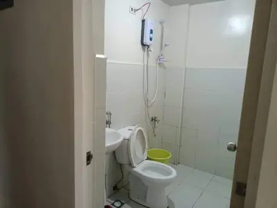 a bathroom with a toilet and a shower and a sink at Mavs transient inn kassel residences in Manila