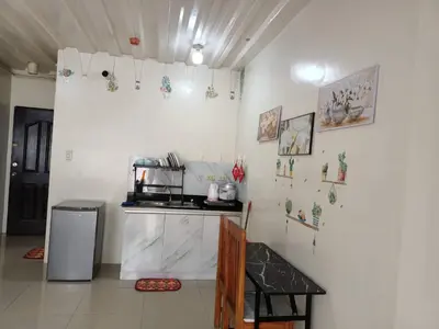 a kitchen with white walls and a counter top at Mavs transient inn kassel residences in Manila