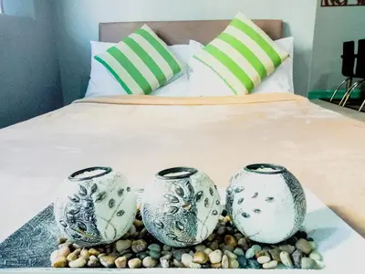 two blue and white vases sitting on a bed at Forbes Area BGC Taguig Manila in Manila