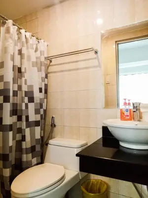 a bathroom with a toilet and a sink at Forbes Area BGC Taguig Manila in Manila