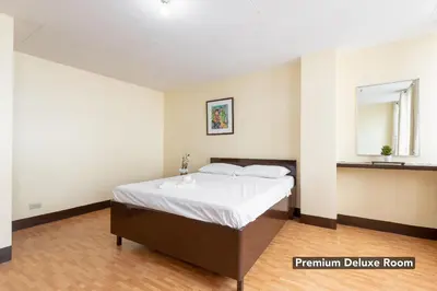 a bedroom with a bed and a sink in it at Victoria Mansions in Manila