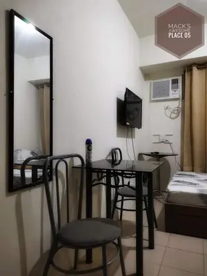 a room with a table and two chairs and a mirror at Macks Awesome Place 05 with Netflix and FastUnliwifi in Manila
