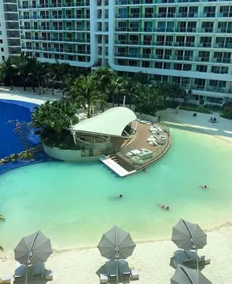 an aerial view of a large swimming pool in a resort at AZURE C5 MAN-MADE BEACH BALCONY Multiple Units in Manila