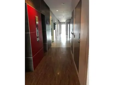a hallway with a long corridor with red walls and wooden floors at Shanilyn Residency Urban Deca Towers EDSA Mandaluyong,UNLIMITED INTERNET AND NETFLIX in Manila