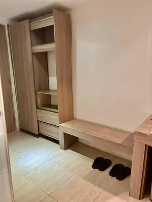 a room with a closet with shoes on the floor at The E-Hotel Makati in Manila