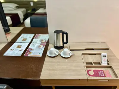 a coffee maker on a table in a hotel room at The E-Hotel Makati in Manila