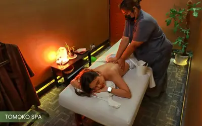 a woman getting a massage in a bath tub at Acacia Hotel Manila in Manila