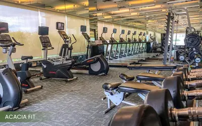 a gym with a bunch of treadms and cardio machines at Acacia Hotel Manila in Manila