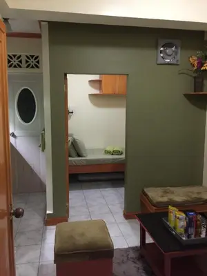 a living room with a couch and a bed at Las Pinas Serviced Apartment in Manila