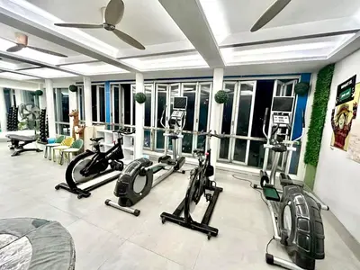 a gym with treadmills and exercise bikes in a room at Selah Pods Hotel Manila in Manila