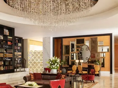 a living room with a large chandelier at Raffles Makati in Manila