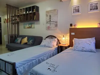 a room with two beds and a couch at Jen's Paranaque City Apartment in Manila