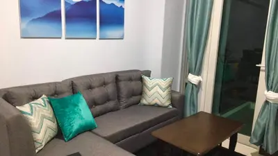 a living room with a couch and a table at F-10C Parkside Villas in Manila