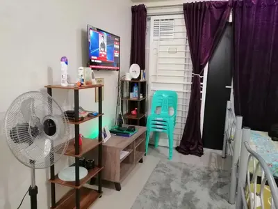 a room with a fan and a chair in it at Condo Transient Near NAIA Airport-Unlimited Internet v2 in Manila