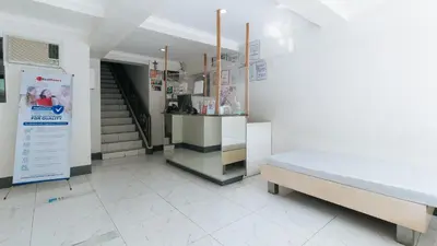 a hospital room with a bed and a staircase at RedDoorz at Samat Mandaluyong in Manila