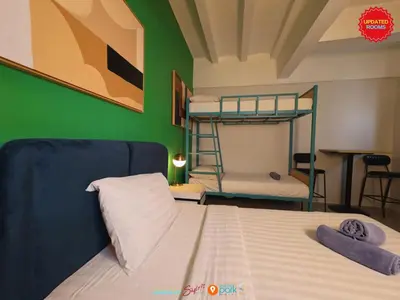 a bedroom with two bunk beds and a green wall at Citizen Hotel in Manila