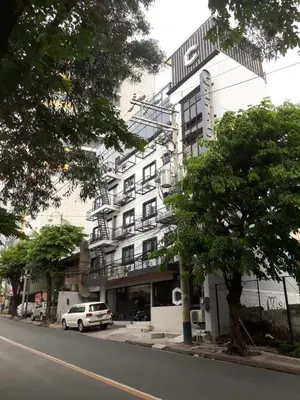 a tall white building on the side of a street at Citizen Hotel in Manila