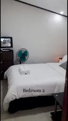 a bedroom with a bed with two towels on it at Estien's cozy home in Malagasang Primero