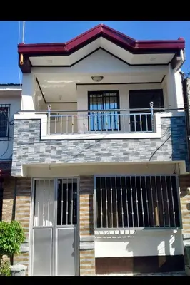 a large house with a balcony and a porch at Estien's cozy home in Malagasang Primero