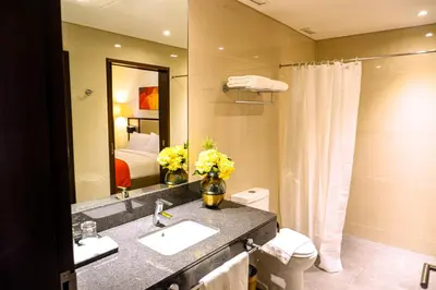 a bathroom with a sink and a toilet and a mirror at Hotel Lucky Chinatown Binondo Manila in Manila