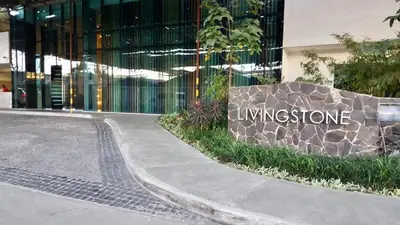 a sign for the entrance to a building at Great 1BR Aqua Livingstone with Netflix, Pool & Gym in Manila