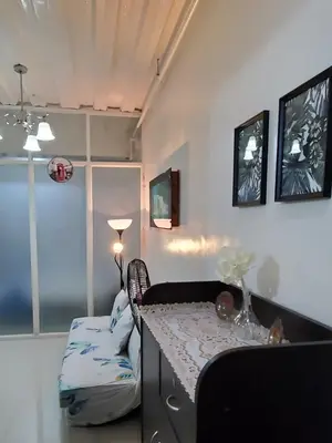 a room with a counter and a table and chairs at Jen's Paranaque City Apartment in Manila