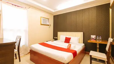 a hotel room with a bed and a desk and a desk at RedDoorz Plus at Winter Benitez in Manila