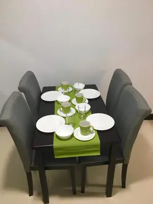 a table with plates and glasses on it at Ameer Condotel @ Parkside Villa in Manila