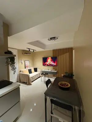 a living room with a bed and a tv on the wall at AZURE URBAN RESORT RESIDENCE R&C - Parañaque in Manila